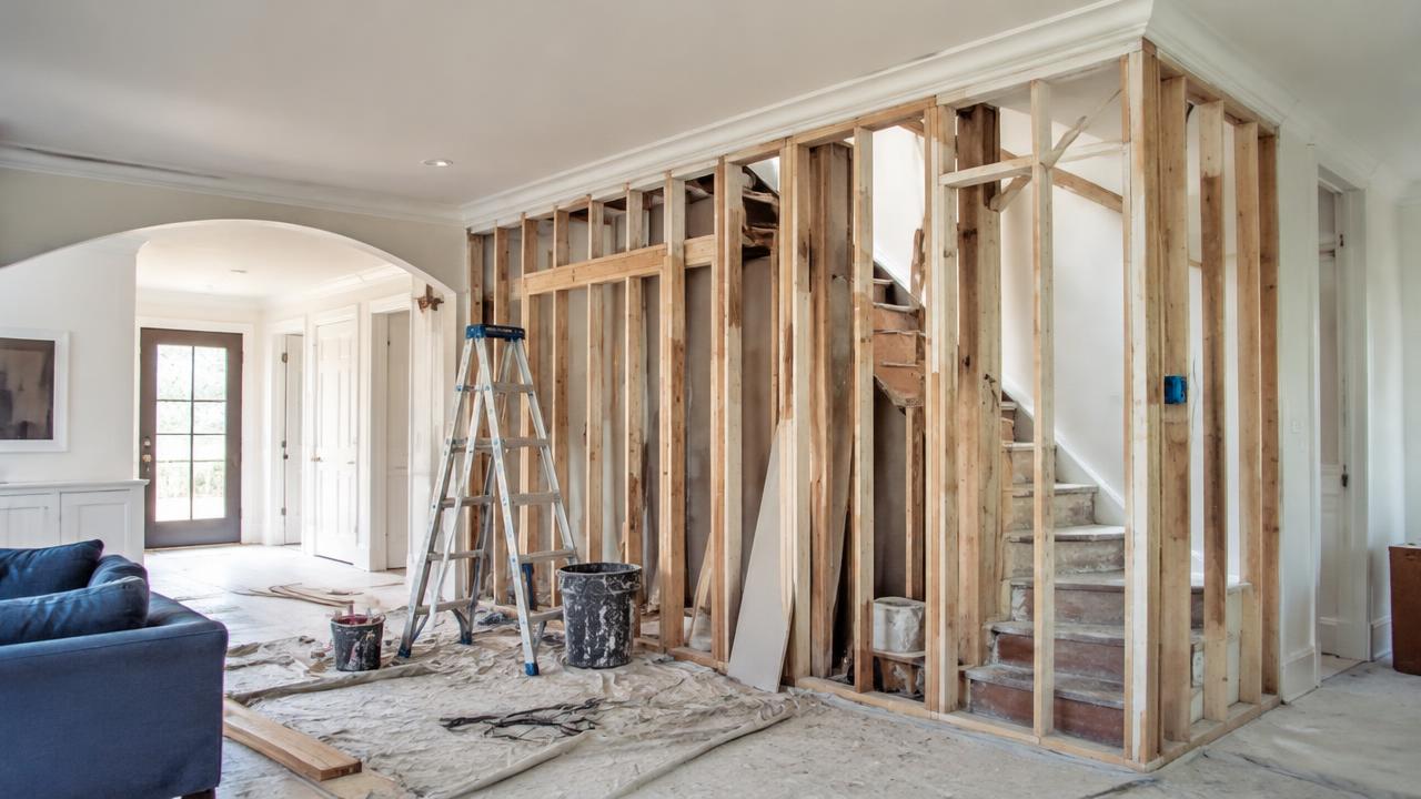 A home renovation with new framing and drop cloths